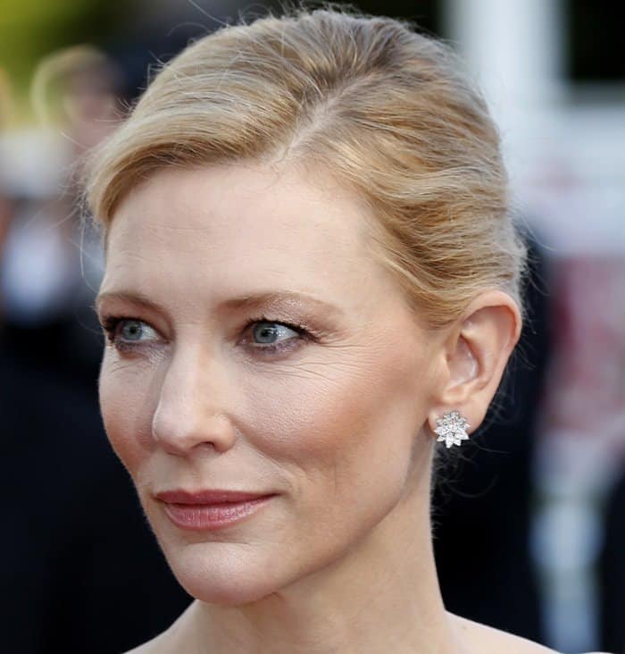 Cate Blanchett radiates timeless elegance at Cannes, her soft glam makeup and diamond floral earrings highlighting her luminous blue eyes and refined poise