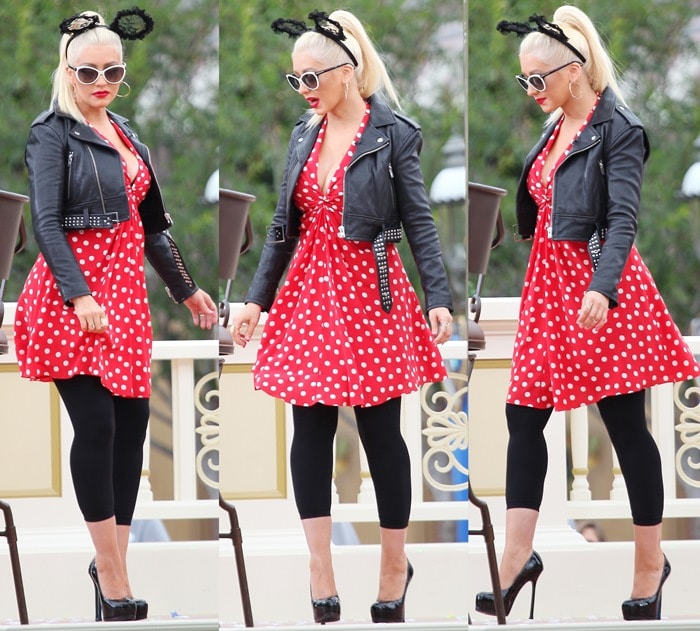 Christina Aguilera channels playful pin-up glamour in a Saint Laurent polka-dot dress and towering Yves Saint Laurent Tribute double-platform pumps, styled with an IRO Zekina leather jacket, Tutu du Monde lace mouse-ear headband, Tom Ford Telma sunglasses, Parulina thorn hoops, and a Suneera Marie ring