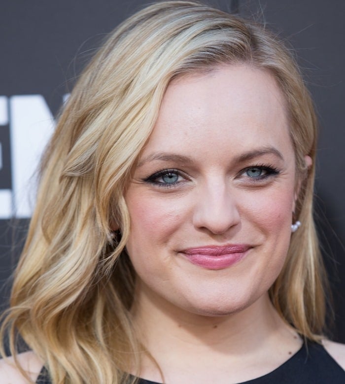 Elisabeth Moss paired softly waved blonde hair with subtle smoky eyes and a glossy pink lip, keeping the beauty look effortless and understated for the Mad Men finale celebration