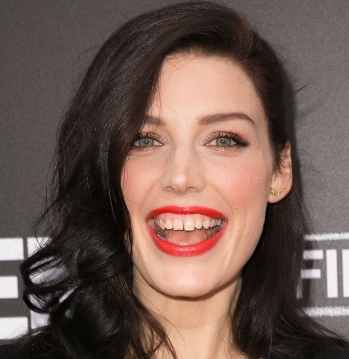 Jessica Paré proudly displays her distinctive gap-toothed smile, a feature that became her signature look