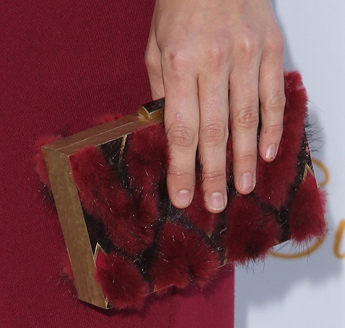 Katharine McPhee toting a box clutch featuring furry red details