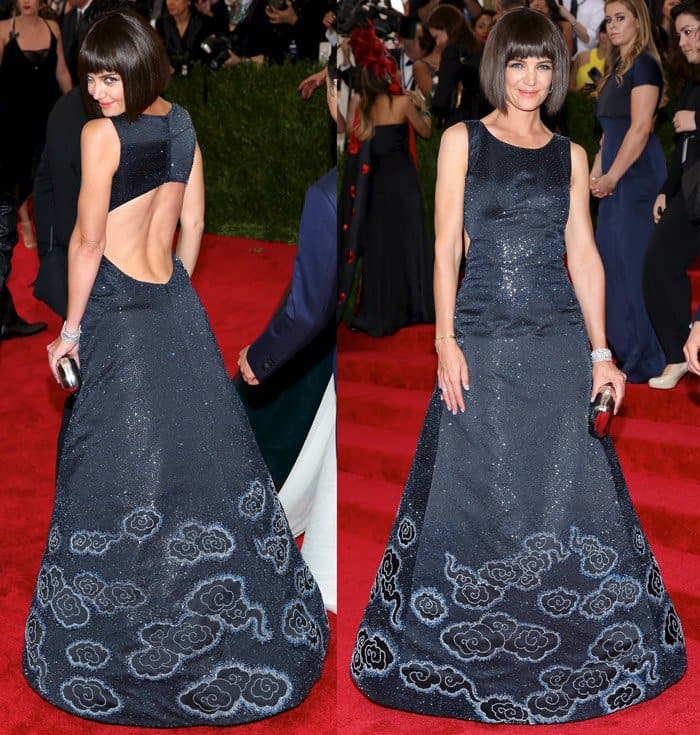 Katie Holmes caught attention on the Met Gala red carpet in a midnight-blue Zac Posen gown with glittering cloud embroidery, grounding the dramatic silhouette with elegant Roger Vivier heels