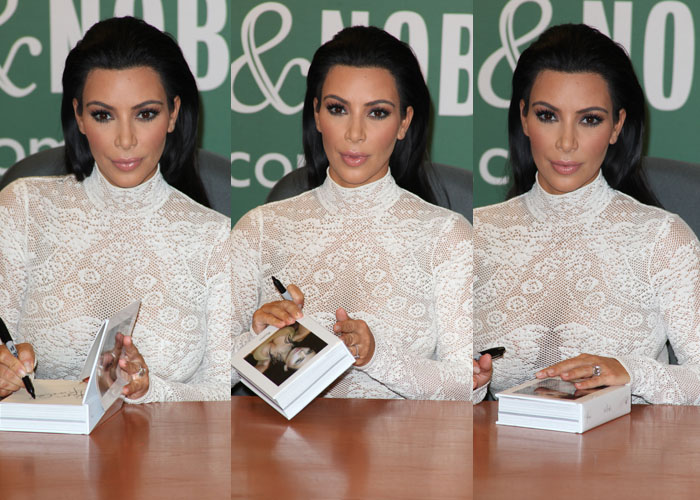 Kim Kardashian signs copies of Selfish for fans, keeping her glam polished with slicked-back hair and nude-toned makeup