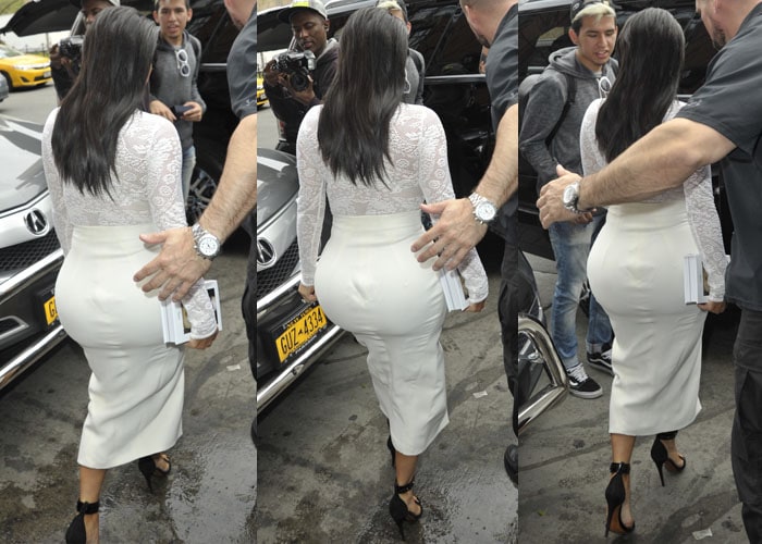 Kim Kardashian steps out in an all-white Christian Dior Spring 2015 lace turtleneck and asymmetrical skirt, paired with Céline “Mulese” sandals