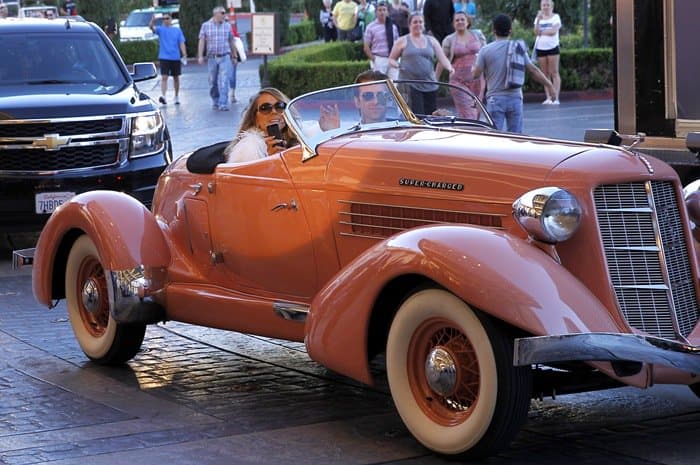 Mariah Carey makes her grand arrival in a classic pink 1936 Auburn Boattail convertible at Caesars Palace in celebration of her upcoming residency in Las Vegas on April 27, 2015