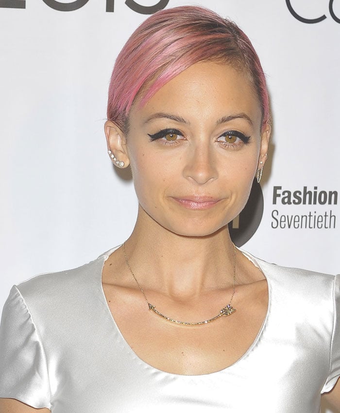 Nicole Richie's dramatic makeup with heavy winged eyeliner and pale pink lipstick
