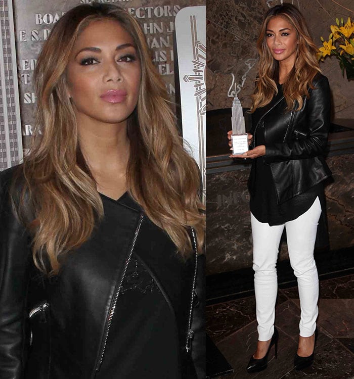 Nicole Scherzinger wore white pants with a black top and a black leather jacket