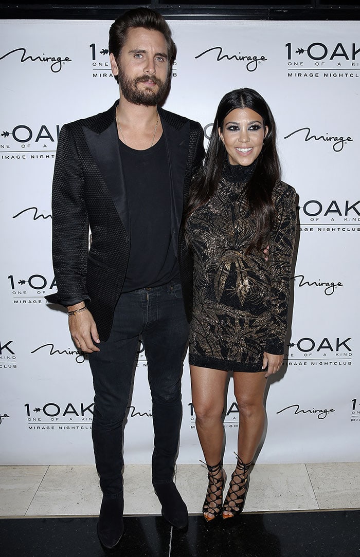 Scott Disick exudes effortless sophistication in an all-black ensemble with a sleek blazer, while Kourtney Kardashian stuns in a shimmering black-and-gold mini dress paired with strappy lace-up heels