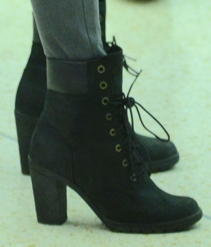 Side view highlights the boot’s structured ankle support, thick lug sole, and elevated heel that blends workwear durability with feminine edge