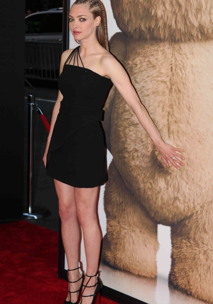 Amanda Seyfried flaunts her incredible legs in a strappy little black dress by Mugler