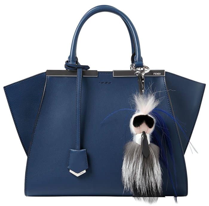 A navy leather Fendi handbag styled with the iconic “Karlito” fur bag charm