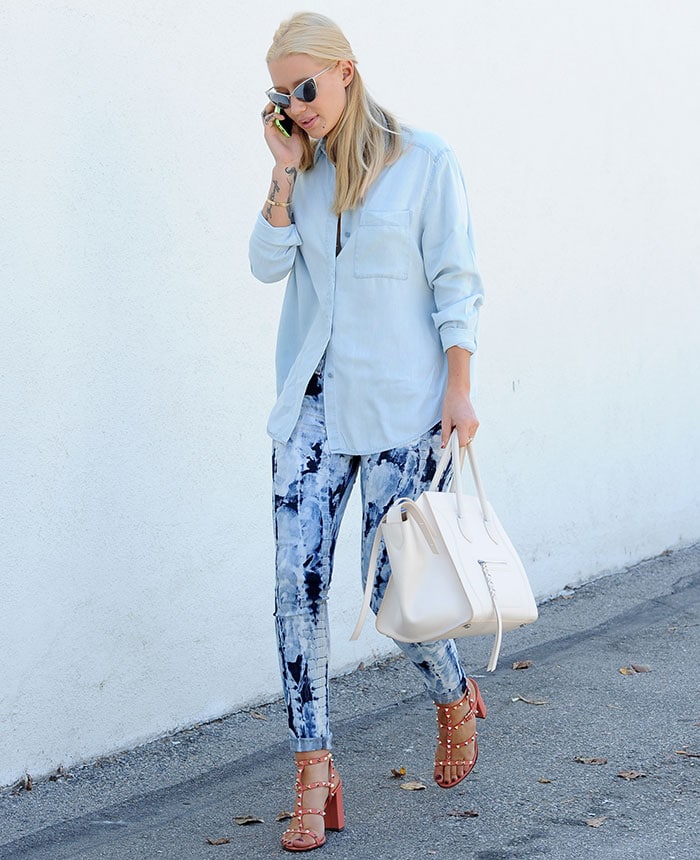 Iggy Azalea rocked a light blue loose-fitting button-down shirt and patterned skinny jeans