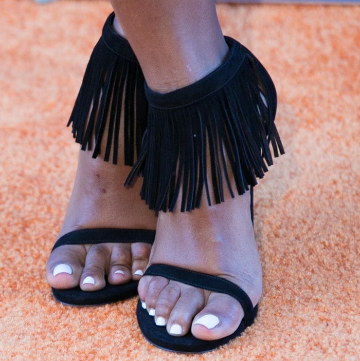 The suede Stuart Weitzman Lovefringe sandals add texture and movement with their dramatic swaying ankle fringe