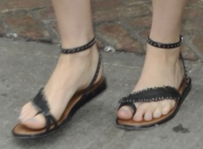 Jennifer Lawrence completes her relaxed summer look with a pair of flat, bohemian-inspired Coach sandals