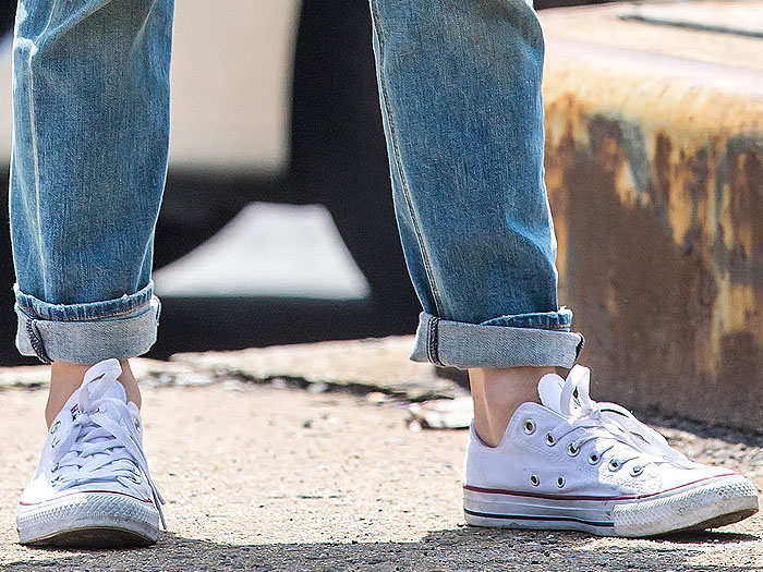 Jennifer Lopez sports worn-in white Converse Chuck Taylor All Star low-tops with cuffed jeans