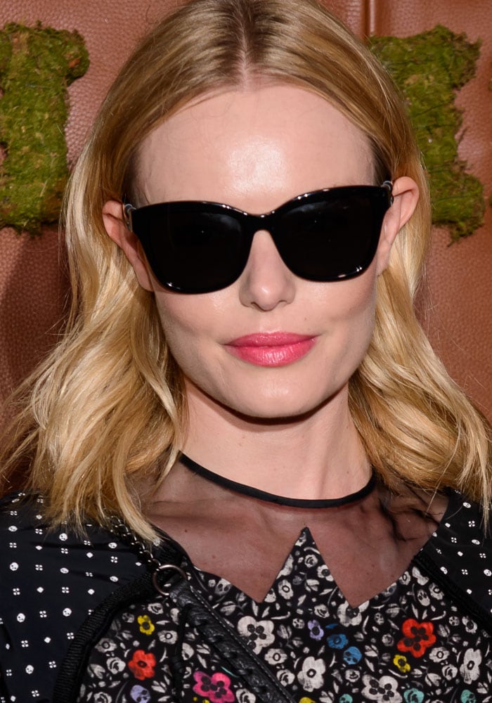Kate Bosworth completes her look with sleek black oversized sunglasses, a soft pink lip color, and loose, shoulder-length blonde waves for a polished yet effortless vibe