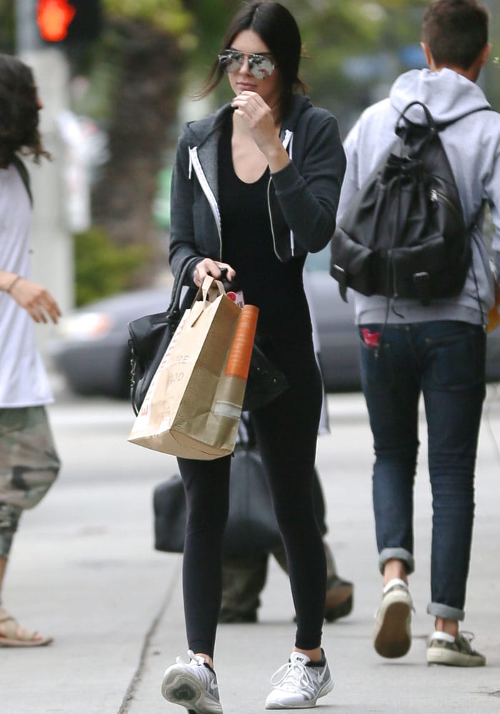Kendall Jenner completes her casual look with a pair of sleek Nike Flyknit Lunar 2 sneakers