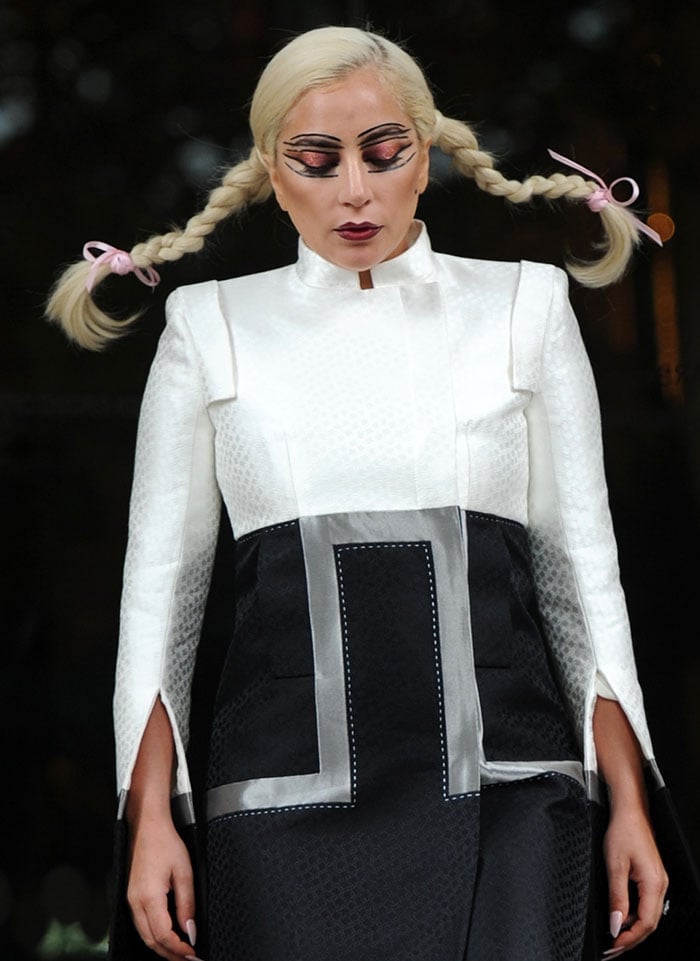 Lady Gaga wore Pippi Longstocking plait pigtails and crazy makeup with glittery red eye shadow and layers of thick black eyeliner, outlining her eyes, eyebrows, and eyelids