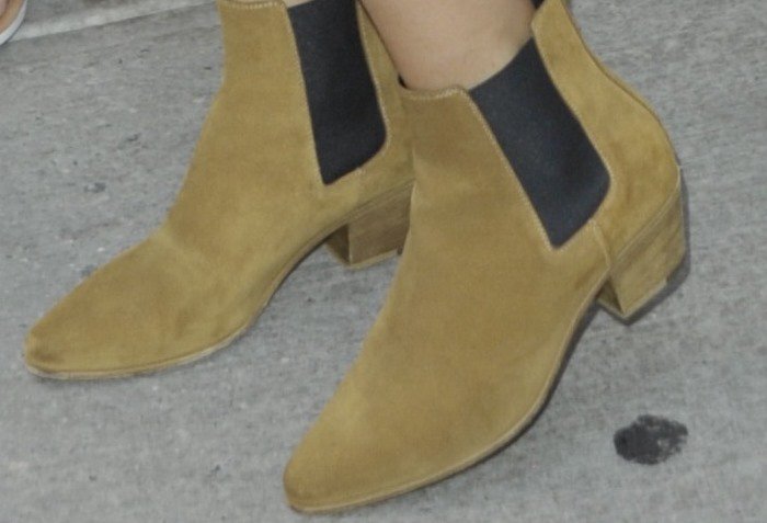 A closer look at Selena Gomez’s Saint Laurent Wyatt suede Chelsea boots reveals the signature elongated almond toe and stacked Cuban heel that define Hedi Slimane’s sleek, rock-inspired silhouette