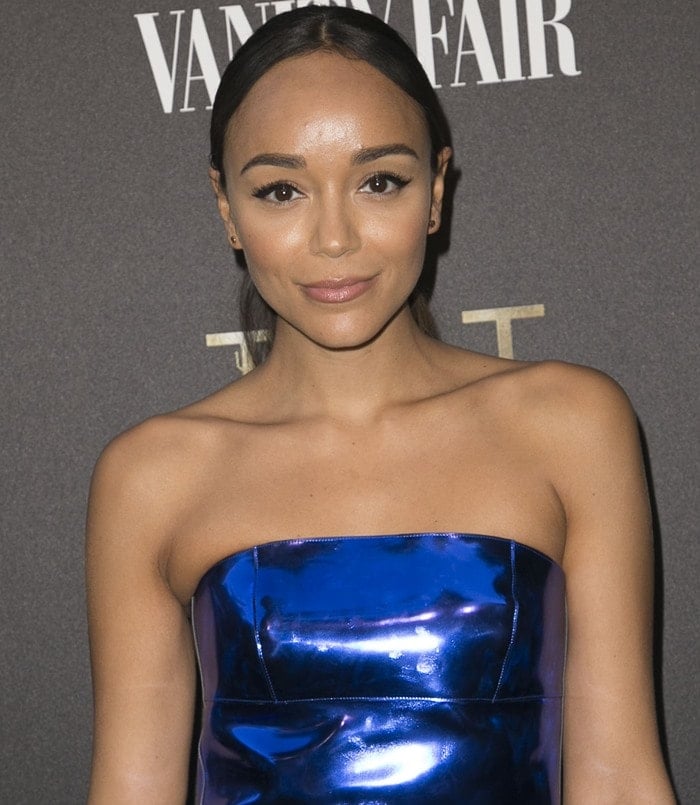 Ashley Madekwe shows off her futuristic metallic-blue Emporio Armani dress in a chic strapless silhouette at the TUT event