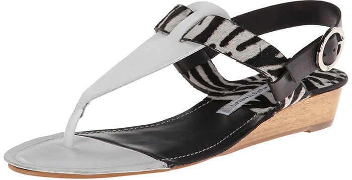 A black-and-white zebra-striped version of the DVF “Darling” sandal offers a cooler, high-contrast take on the same signature T-strap silhouette and one-inch wedge heel