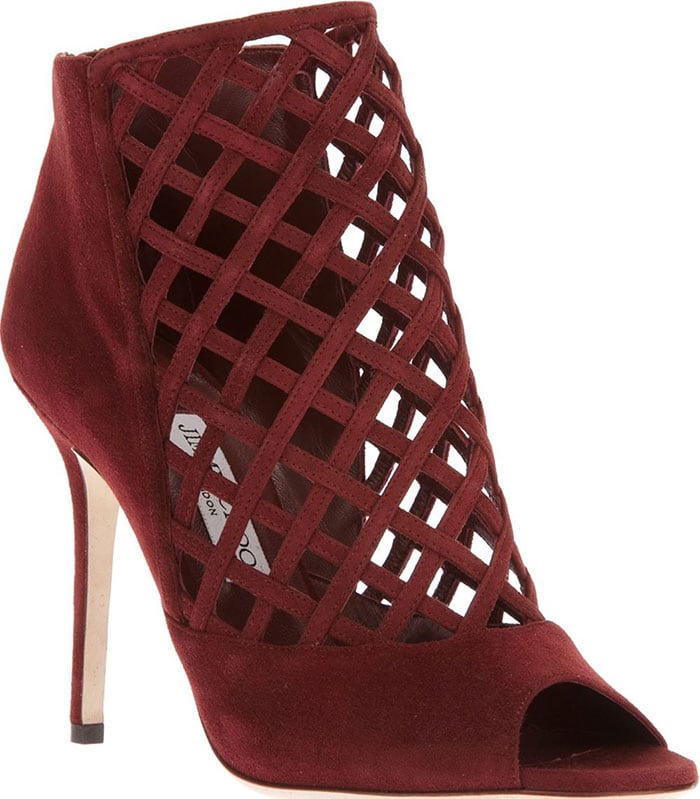 The maroon red Jimmy Choo “Dane” ankle boots make a bold statement with their suede lattice cutouts, peep-toe silhouette, and sky-high stiletto heel that adds instant drama to any look