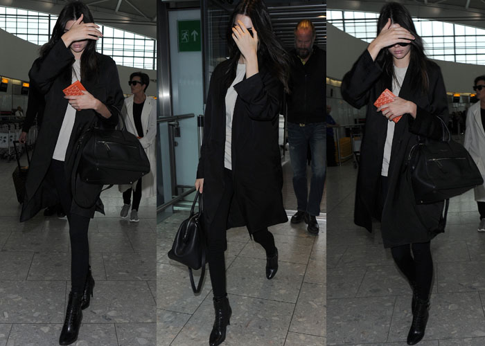 On July 14, 2015, Kendall Jenner arrived at Heathrow Airport wearing Prada top-buckle lace-up booties, a Marc Jacobs smooth medium incognito bag in black nickel, and a Goyard passport holder
