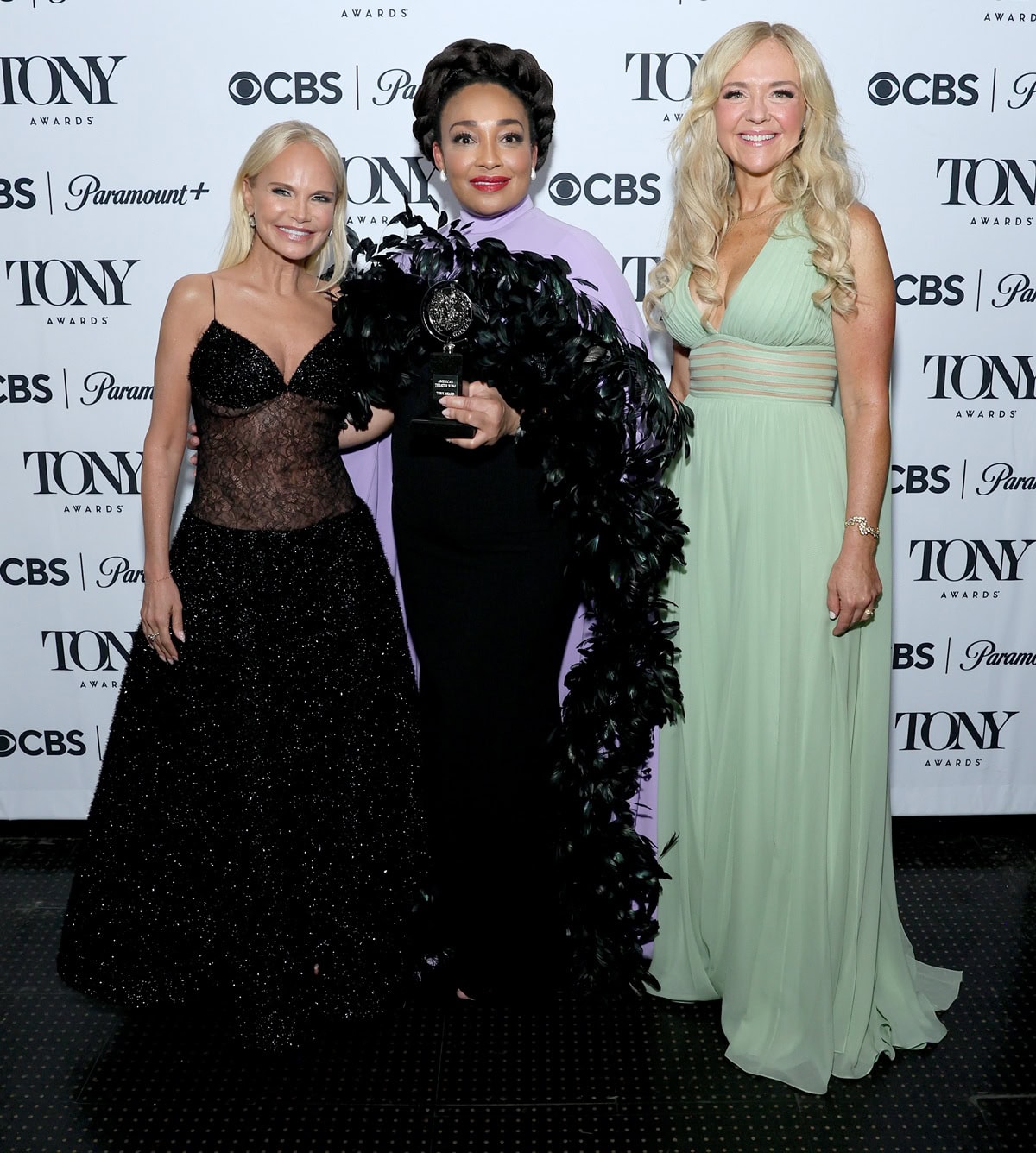 Kristin Chenoweth looks especially petite beside Natalie Venetia Belcon and Rachel Bay Jones at the 78th Annual Tony Awards on June 8, 2025, her small frame standing out amid the statuesque gowns at Radio City Music Hall