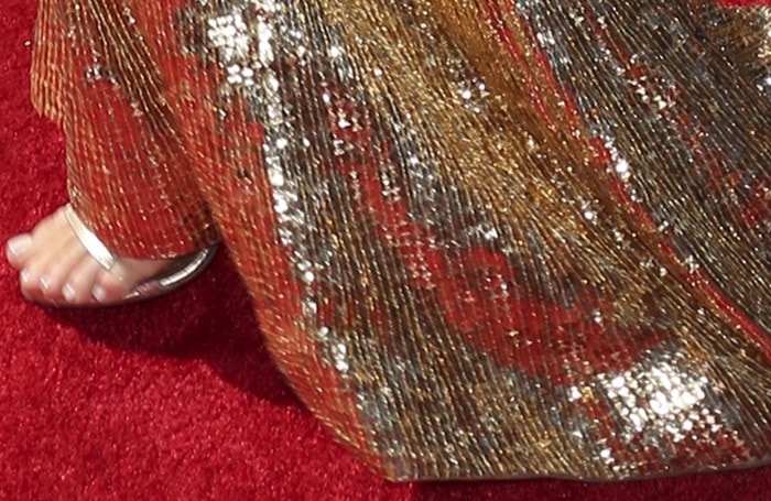 Kylie Jenner's silver Tamara Mellon sandals peek out from beneath her dazzling gold sequined Shady Zeineldine gown, perfectly complementing her chic neutral pedicure on the 2015 ESPY Awards red carpet