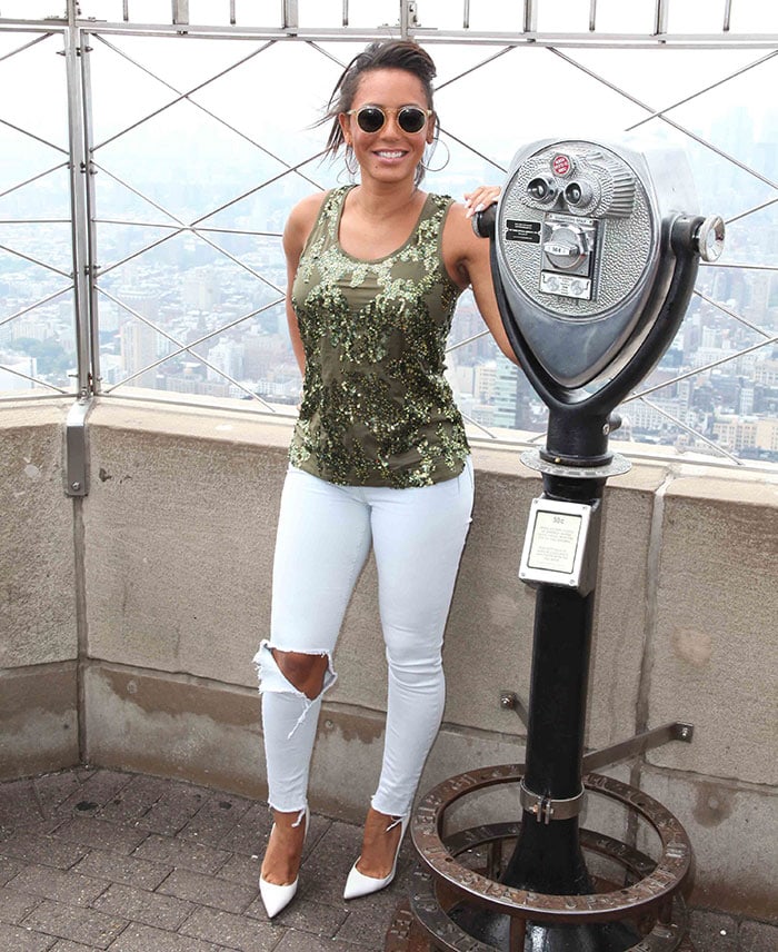 Mel B accessorized with hoop earrings, a ring, a watch, and some bracelets