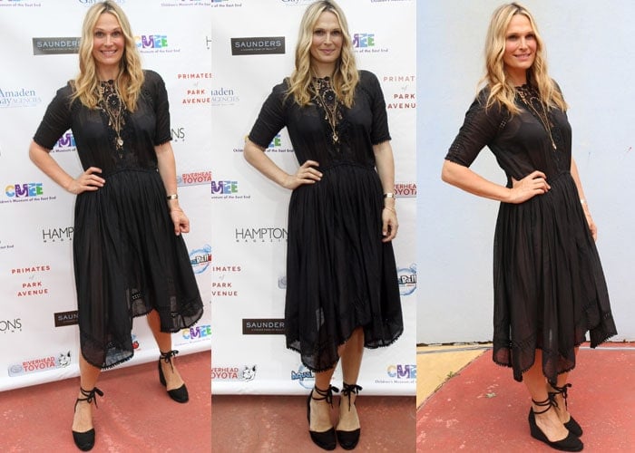 The model keeps things elegant in a black lace midi dress styled with black Castañer “Carina” wedges at the Hamptons “Super Saturday” fundraiser