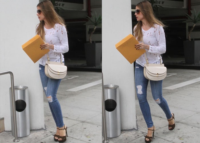 Sofia Vergara clutches a large envelope as she strides through Beverly Hills in sky-high Saint Laurent “Bianca” platform heels, effortlessly elevating her ripped denim and distressed white tee with signature off-duty glamour