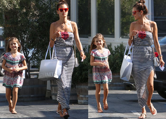 Alessandra Ambrosio styled a striped tube maxi dress with white Gucci “Tess” thong sandals while shopping with her daughter Anja after school in Los Angeles, effortlessly channeling her signature laid-back California style