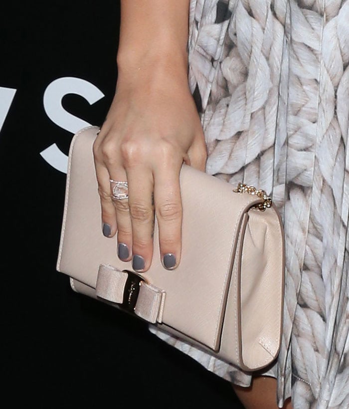 Demi Lovato toting a bisque Salvatore Ferragamo “Vara” bow clutch