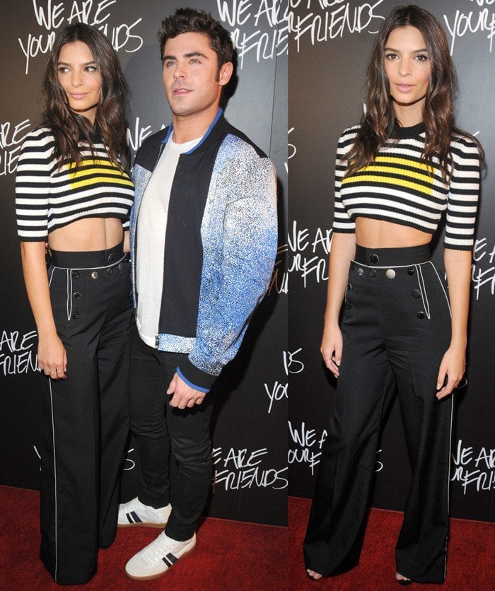 Standing beside Zac Efron, Emily grounds the look with sleek open-toe heels, letting the tailored wide-leg pants and cropped knit create a clean, modern red-carpet statement