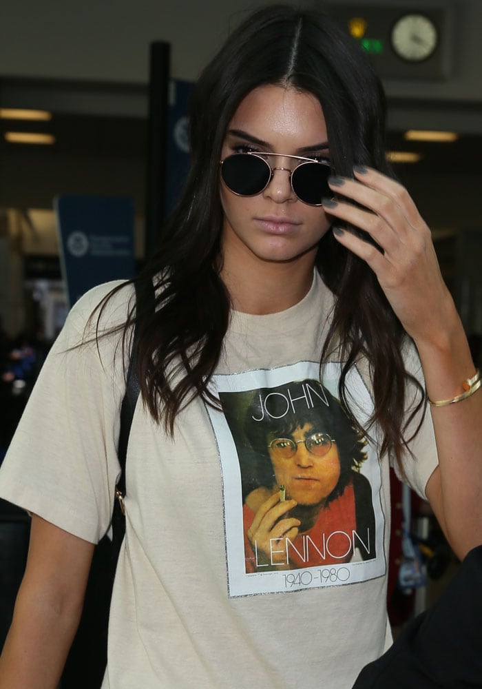 Kendall Jenner wearing a vintage-style John Lennon graphic tee with his name and birth-death years (1940-1980) displayed