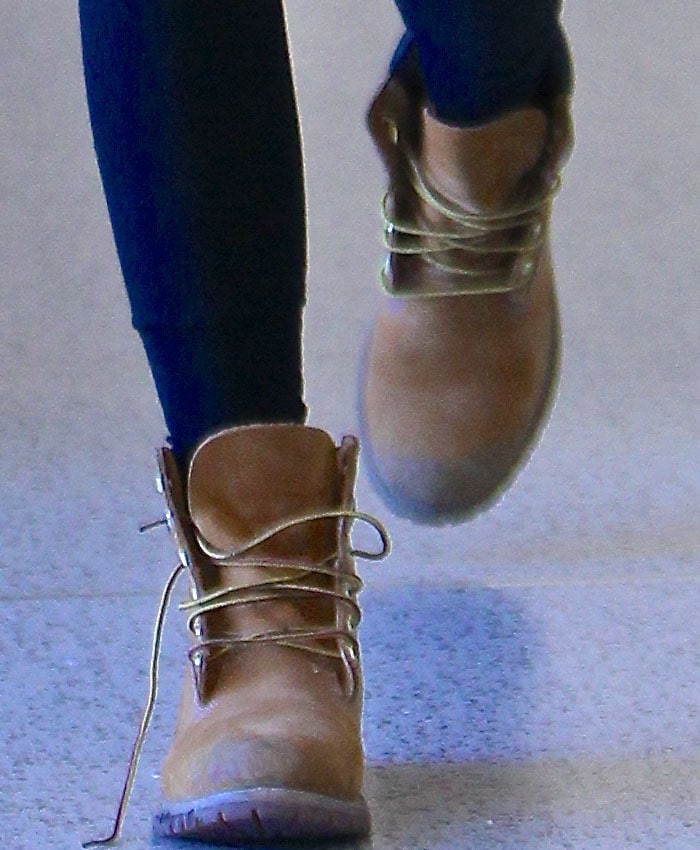 Kendall Jenner showcases her tan suede Timberland flat boots, paired with dark leggings