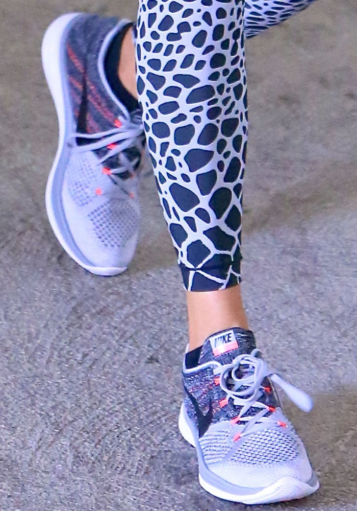 Close-up of Khloé Kardashian’s gray-and-black Nike Flyknit Lunar 3 sneakers, featuring breathable Flyknit uppers and Lunarlon cushioning for lightweight comfort during workouts
