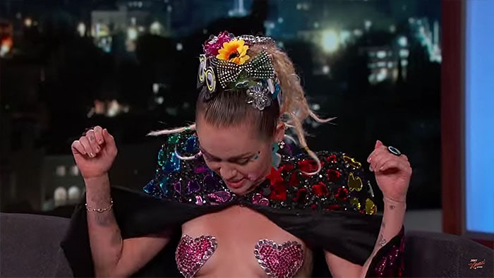 Miley Cyrus flashing the heart nipple tapes she wore during her Jimmy Kimmel Live! guest appearance aired on August 26, 2015