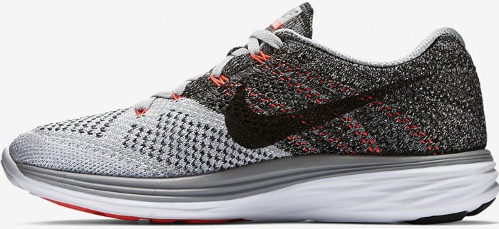 The Nike Flyknit Lunar 3 features a lightweight, form-fitting Flyknit upper in a gradient black, grey, and white colorway, supported by plush Lunarlon cushioning for smooth, responsive strides