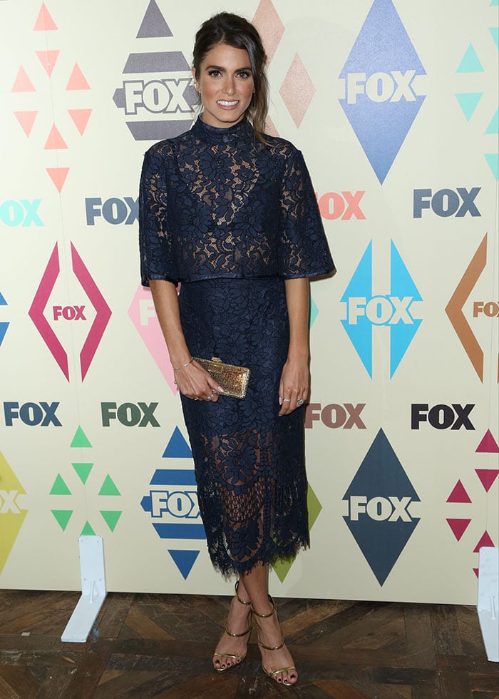 Nikki Reed flashed her legs in a two-piece navy blue floral lace outfit by Lover