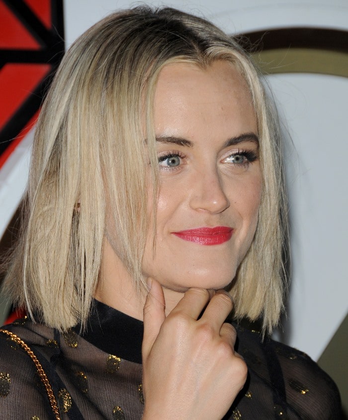 Taylor Schilling shows off a bold red lip and sleek blonde bob with her polished makeup look