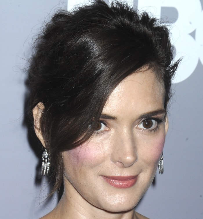 Winona Ryder highlights her expressive features with a swept-up hairstyle and rosy blush at the Show Me a Hero screening in New York City