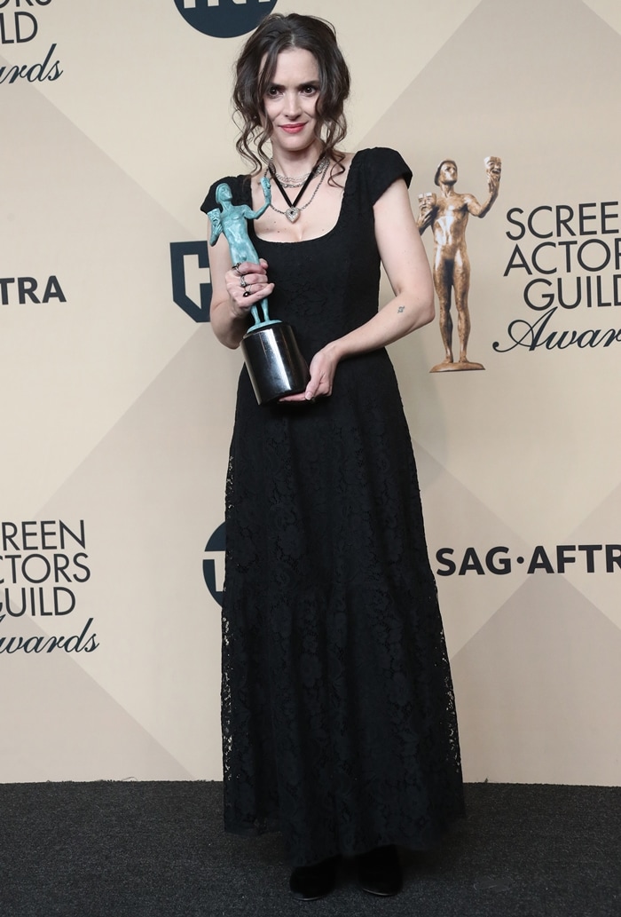 Winona Ryder wears a sentimental black lace gown and her own heirloom jewelry while holding her award backstage at the 23rd Annual Screen Actors Guild Awards