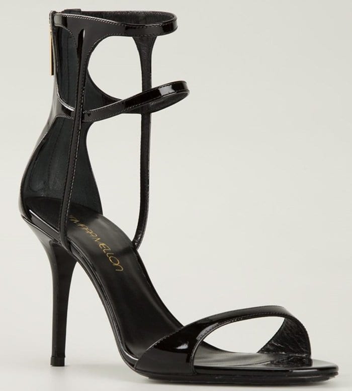 Tamara Mellon’s black patent stiletto sandals, designed with clean straps and a sculpted ankle cage for a striking, modern silhouette