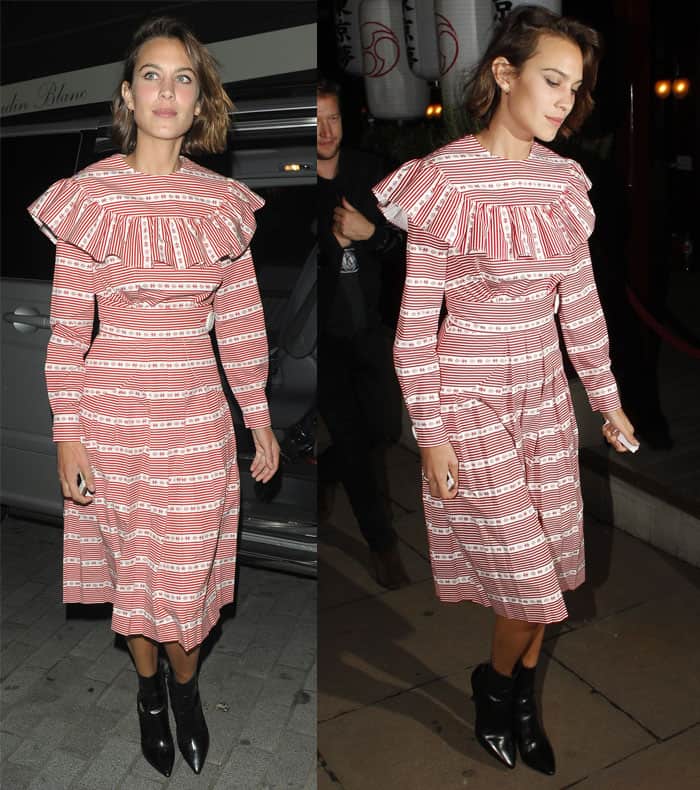 Alexa Chung paired a charming striped dress from the Miu Miu F/W 2015 collection, featuring a lovely red and white pattern and a dainty bib collar, with edgy black pointed-toe booties for a surprising twist