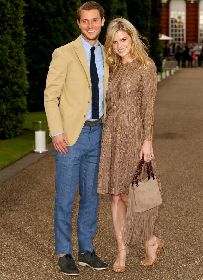 Alice Eve and Alex Cowper-Smith attend the Vogue and Ralph Lauren Wimbledon party at The Orangery on June 22, 2015, in London, with Alice stunning in a chic knit dress paired with strappy sandals and a fringe-accented suede bag