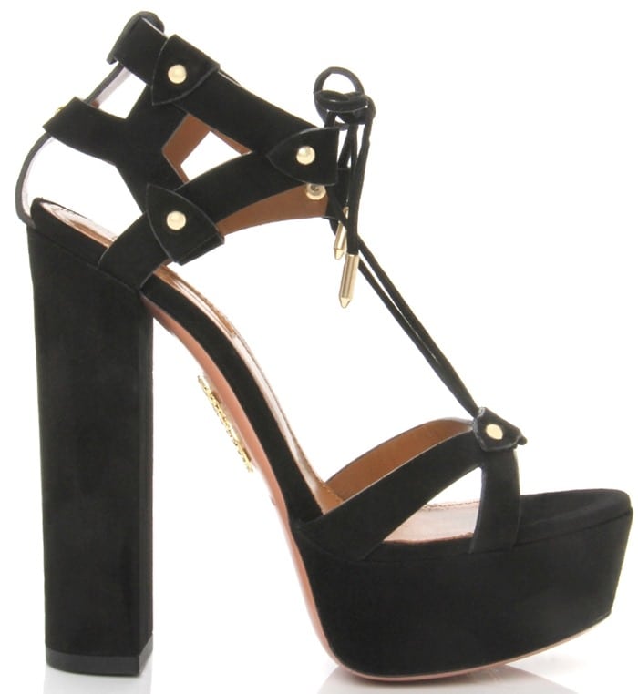 Aquazzura’s black suede “Bel Air” platform sandal features a towering block heel, stud-accented straps, and a chic lace-up ankle tie for bold, height-boosting glamour