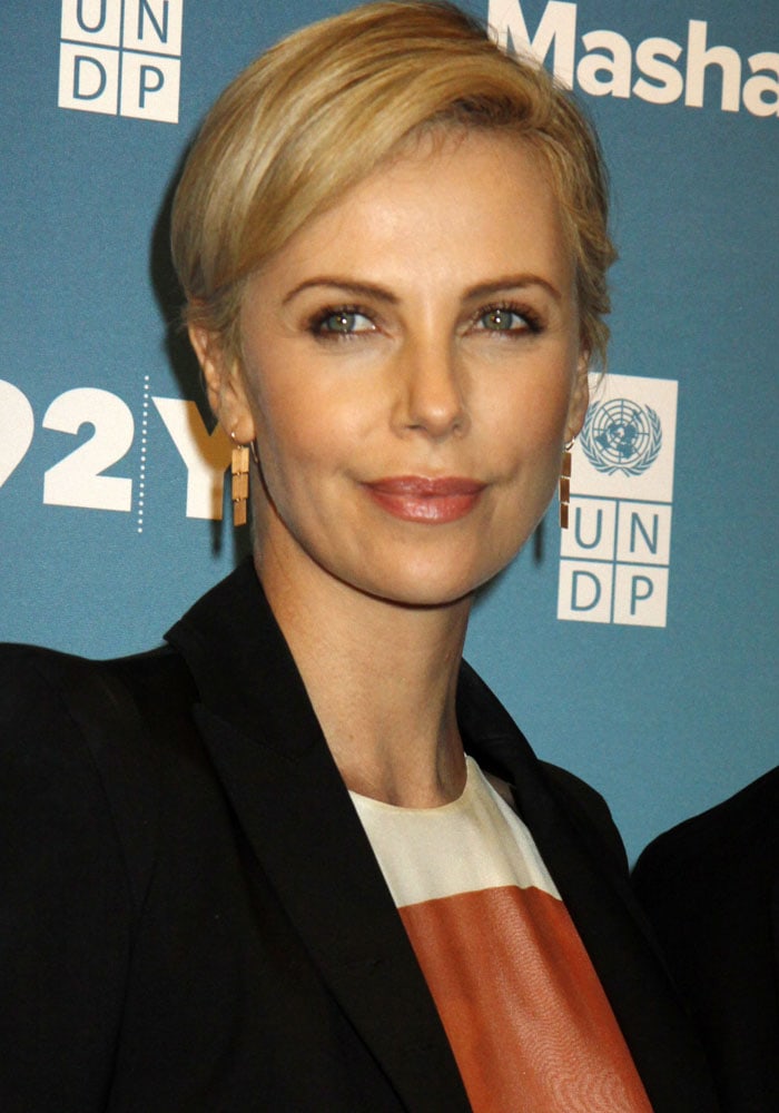 Charlize Theron keeps her beauty look polished and understated with a sleek pixie cut and soft makeup at the 2015 Social Good Summit