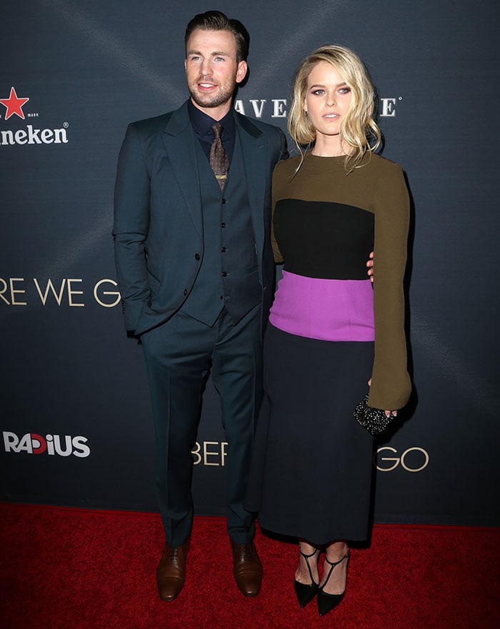 Alice Eve, standing at 5ft 5 ½ (166.4 cm), and Chris Evans, at 6ft 0 (182.9 cm), pose on the red carpet with Alice in a Marni color-block dress and Chris in a sharp three-piece suit